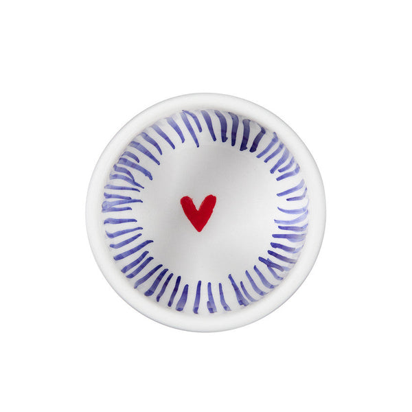 Small white dish with blue concentric circles and a red heart on a white background