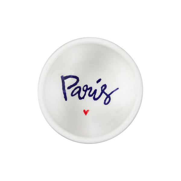 Small white dish with 'Paris' and a heart printed on it against a white background