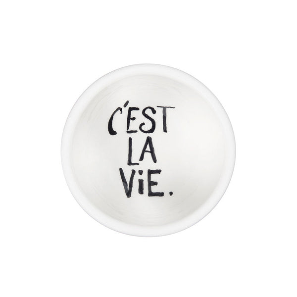 Small white dish with "c'est las vie" painted on it
