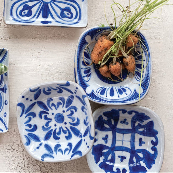 Collection of blue and white ceramic dishes on a light background